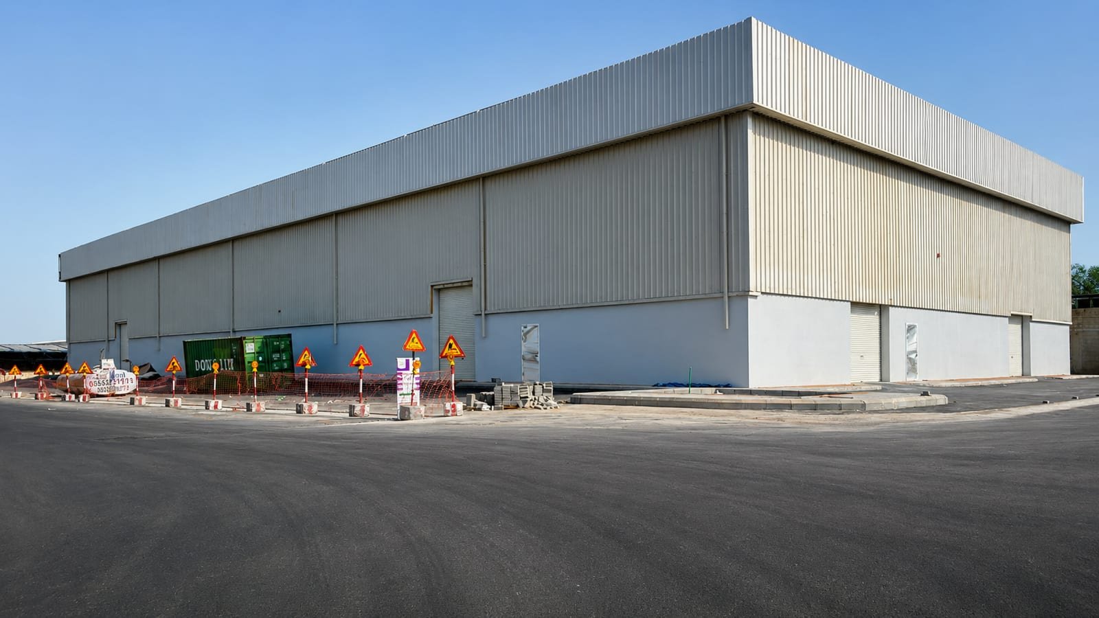 Completed steel-clad industrial warehouse with portal-frame construction